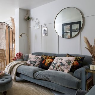 living room with grey velvet sofa and wall panelling
