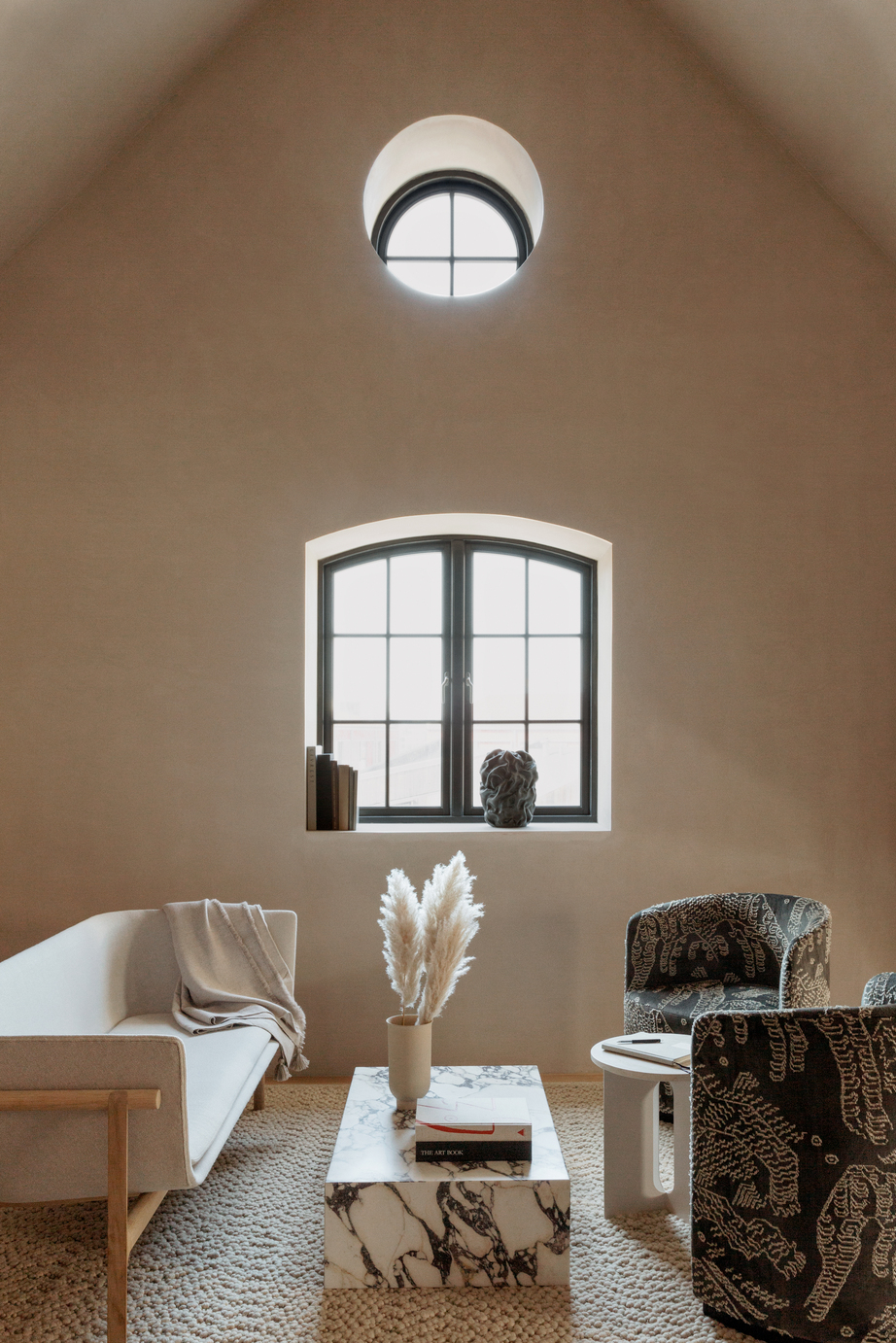 Beige living room with high ceilings and simple decor