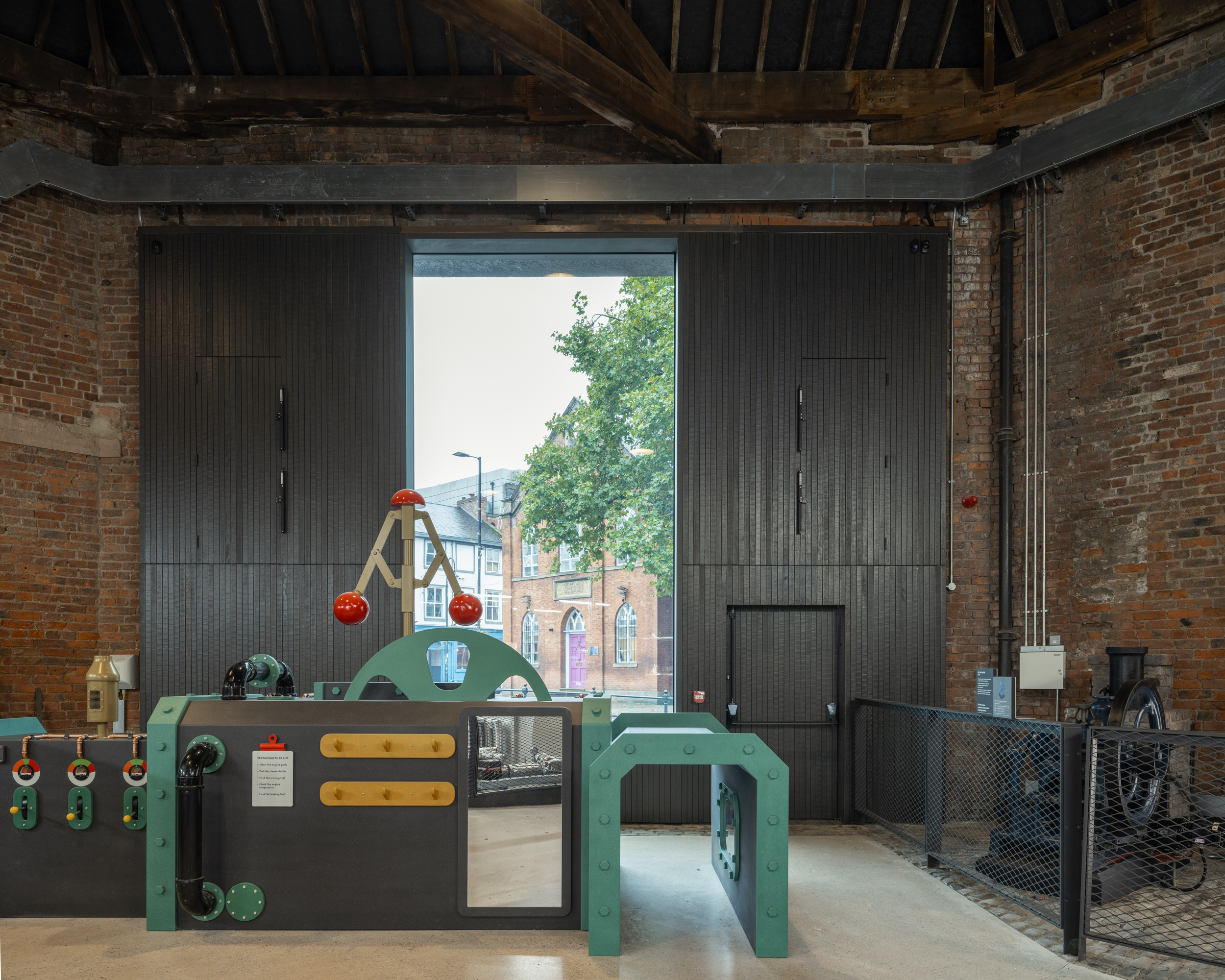 Power Hall by Carmody Groarke, a renovated warehouse with large machines, like old locomotives