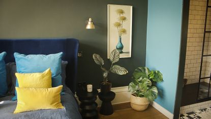 green bedroom with blue wall and yellow accents
