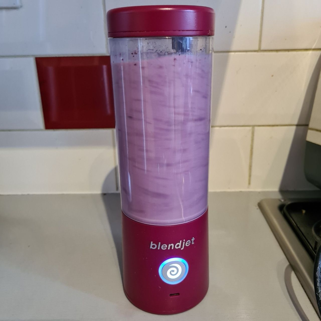 BlendJet 2 filled with a pink berry smoothie.