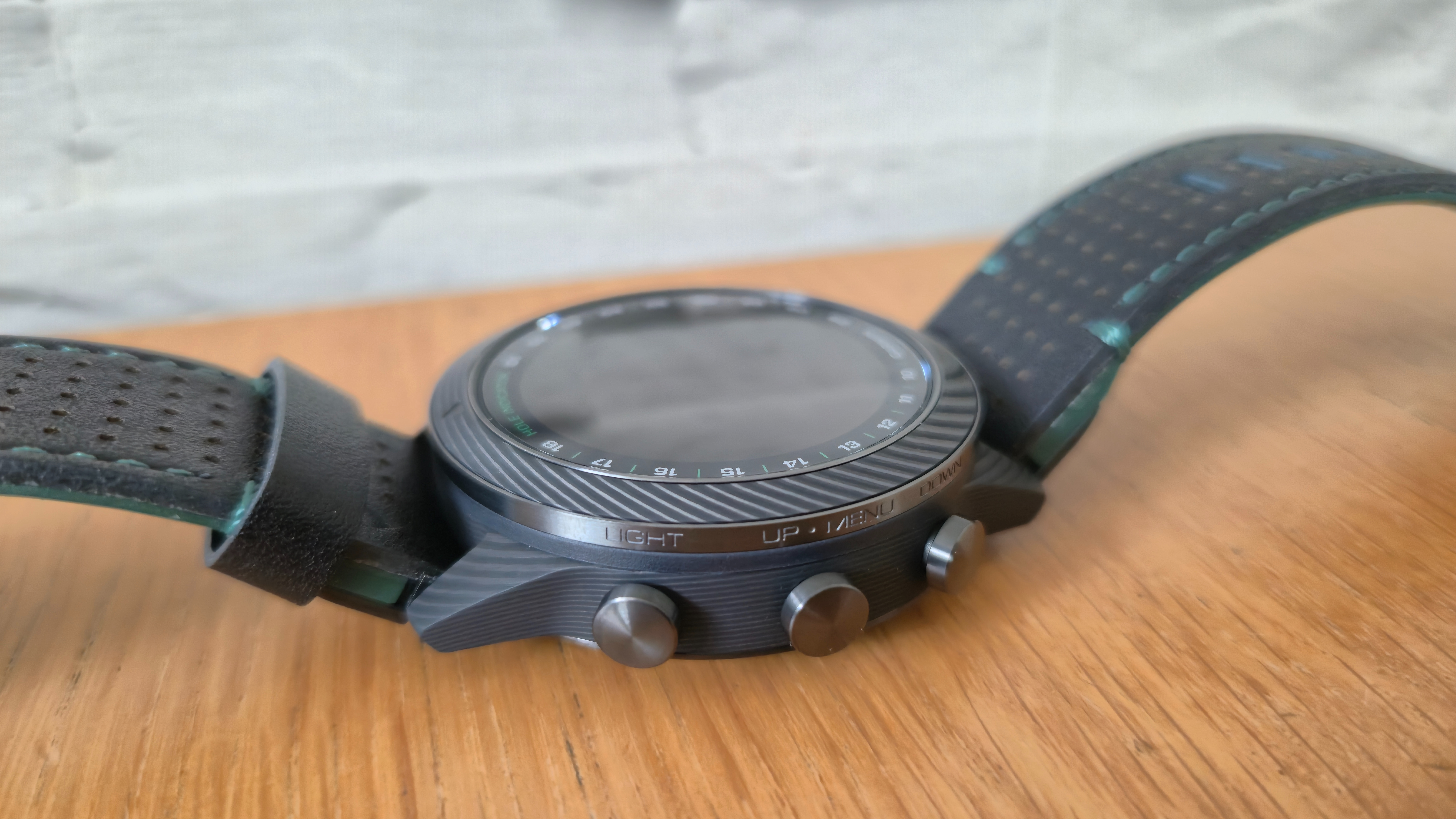The Garmin MARQ Golfer (Gen 2) on a wooden surface