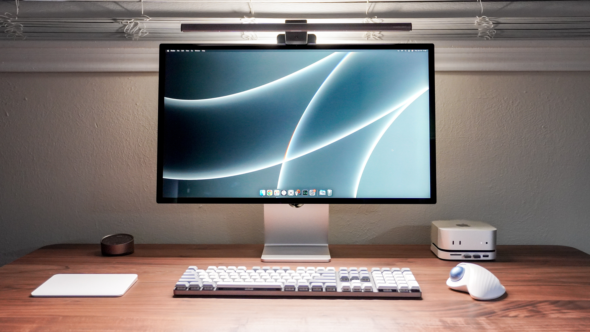 A desk setup built around the Mac mini M4 with an Apple Studio Display on an all wooden desk