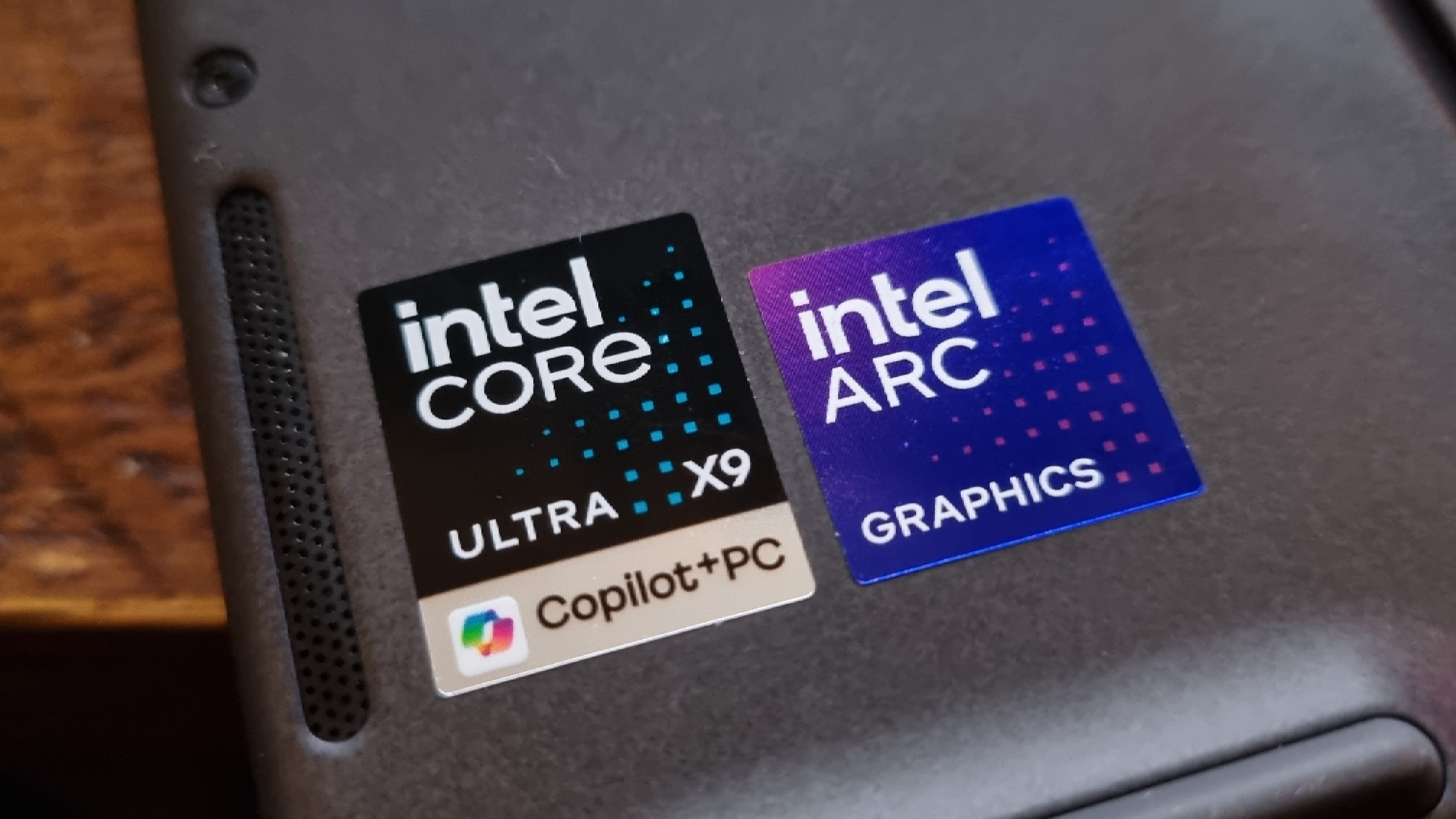 Two badges for the Intel Core Ultra X9 chip and Intel Arc graphics inside a gaming laptop