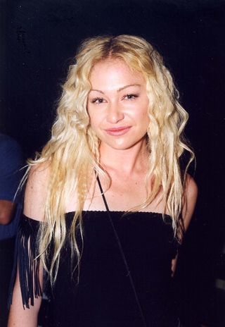 Portia de Rossi with crimped hair as part of an embarrassing hair trends from the '90s round-up