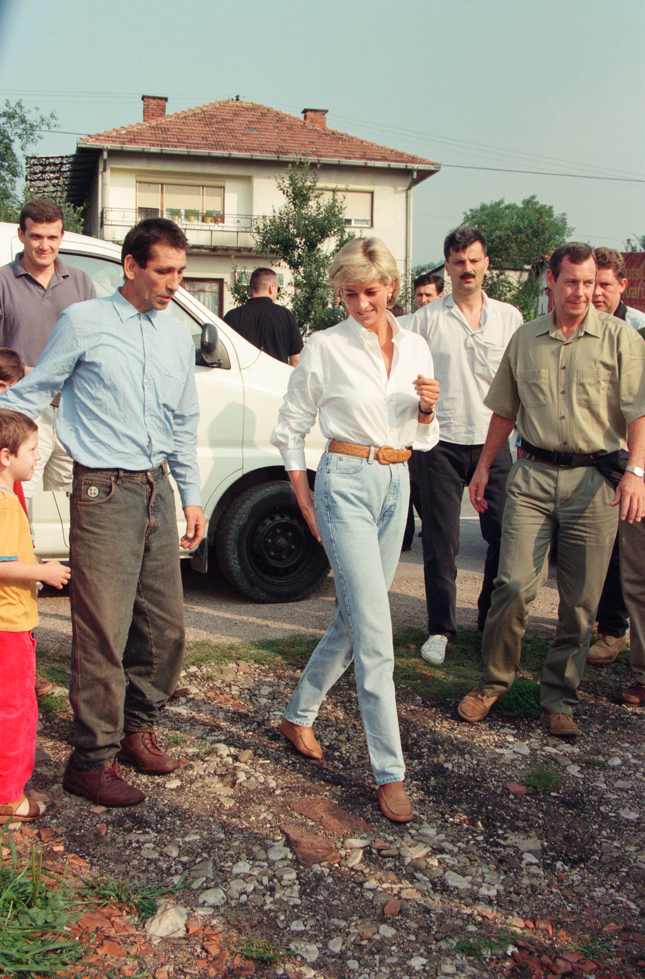 Princess Diana wearing a white shirt and jeans in Bosnia