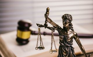 Lady Justice Against Gavel On Book
