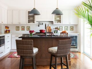 a white kitchen with a small wood kitchen island