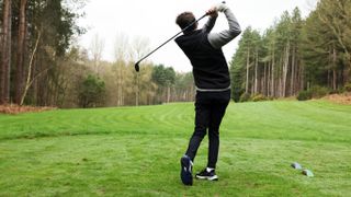 Dan Parker hitting a tee shot wearing the Skechers Go Golf Blade GF Slip-ins