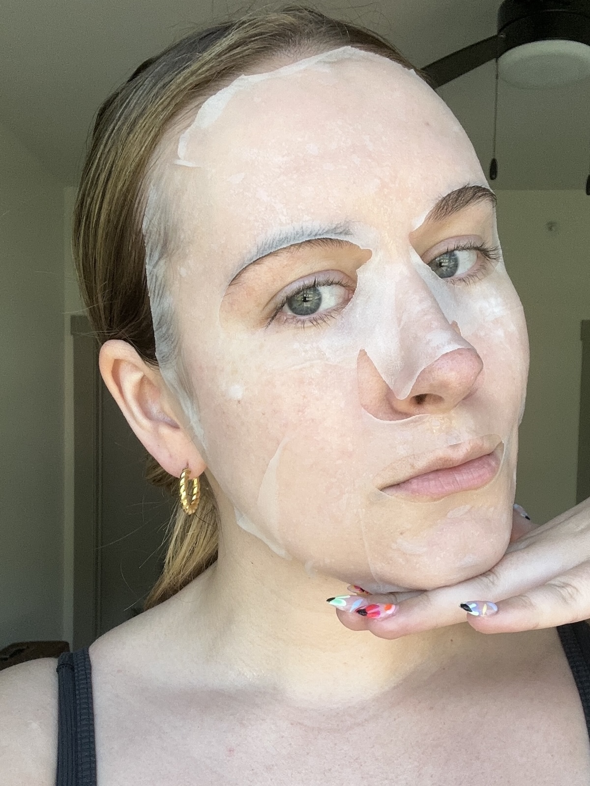 Beauty editor Kaitlyn McLintock wearing ESW Beauty sheet mask.