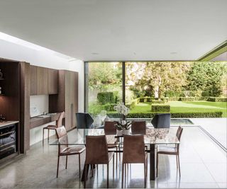 modern kitchen diner with corner sliding doors and wooden fitted furniture