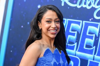 Liza Koshy in a blue dress against a blue background with lettering