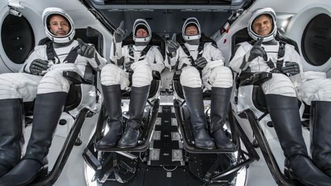 The crew of Axiom Space's Ax-1 mission pose for a photo inside a SpaceX Crew Dragon spacecraft while training. They are: (from left) Mark Pathy; Larry Connor; Michael López-Alegría; and Eytan Stibbe.