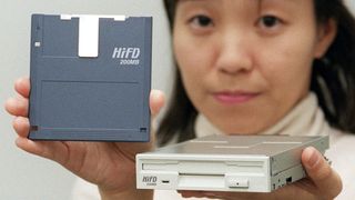 A Sony employee holding up a new floppy disk in 1997