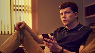 Fleishman is in Trouble Jesse Eisenberg sits on a sofa