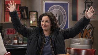 Darlene with hands in air celebrating on The Conners