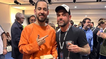 Danny Gomez of Dirty Boy pedals hangs out with Linkin Park who have just revealed that the Ball Buster, Dirty Boy's OOP legacy boost pedal, was all over their comeback LP, From Zero. Here, Mike Shinoda wears an orange long-sleeve.