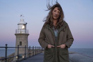 Back To Life: Miri Matteson (Daisy Haggard) stands in the foreground with a lighthouse behind her, her semi-crimped hair blowing into her face