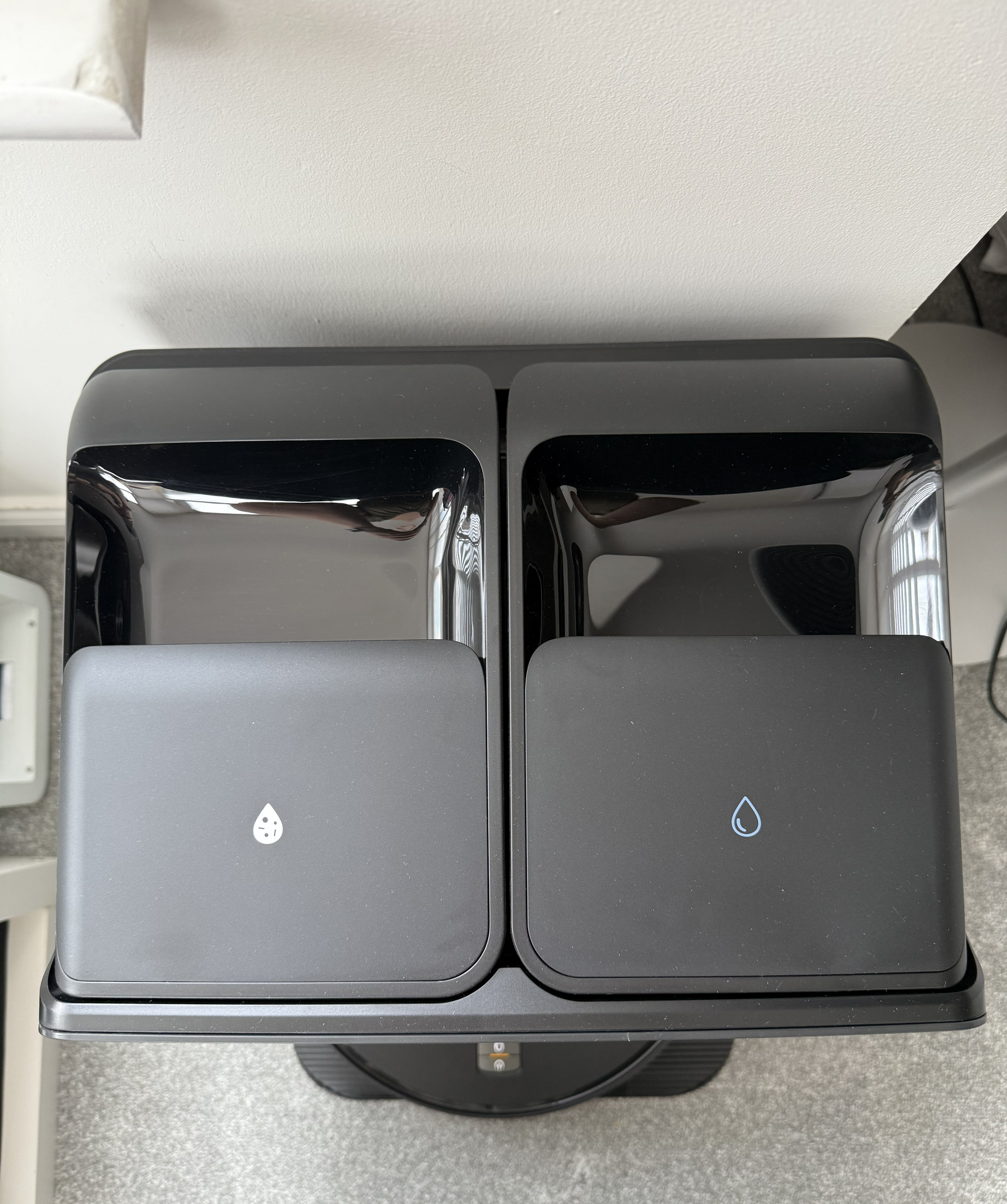 Photograph taken from above of Roborock Saros Z70 cleaning station's clean and dirty water tanks