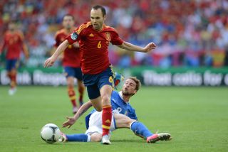 Andres Iniesta goes past Claudio Marchisio in Spain's Euro 2012 final win over Italy.