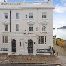 bungalow with white walls glass windows and stone flooring