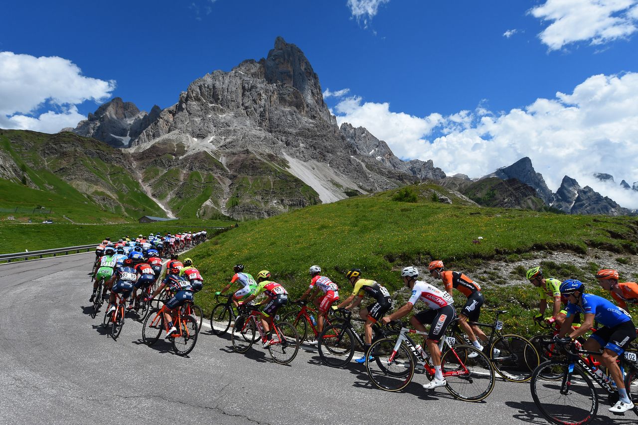 The mountains loom over riders