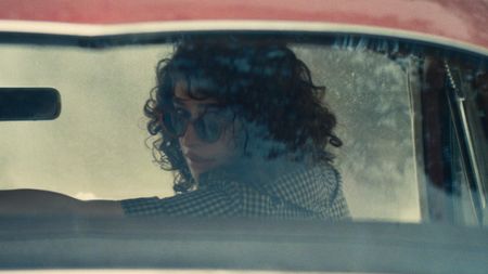 Odessa A'zion as Rachel in a car in marty supreme