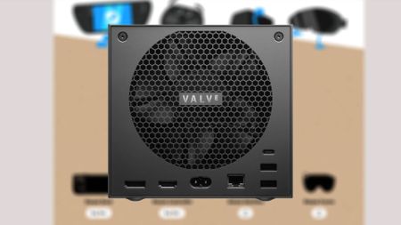 Back view of Steam Machine with fan vent and ports in view with blurred reservation page in backdrop.
