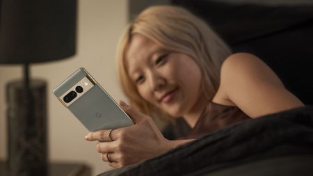 Google Pixel 7 Pro in Hazel colour held by an Asian woman with white hair