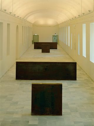 Image of a gallery of wooden shapes in a windowed tunnel shaped room