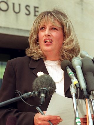 WASHINGTON, DC - JULY 29: Linda Tripp talks to reporters outside of the Federal Courthouse 29 July in Washington, DC, following her eighth day of testimony before the grand jury investigating the Monica Lewinsky affair. Tripp's taped conversations with Lewinsky triggered the sex-and-lies probe dogging US President Bill Clinton. (Photo credit should read WILLIAM PHILPOTT/AFP via Getty Images)