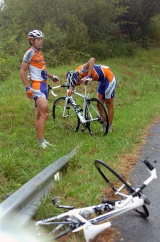 Rabobank's Oscar Freire (L) and Juan Manuel Garate look stunned after crashing on the wet roads.