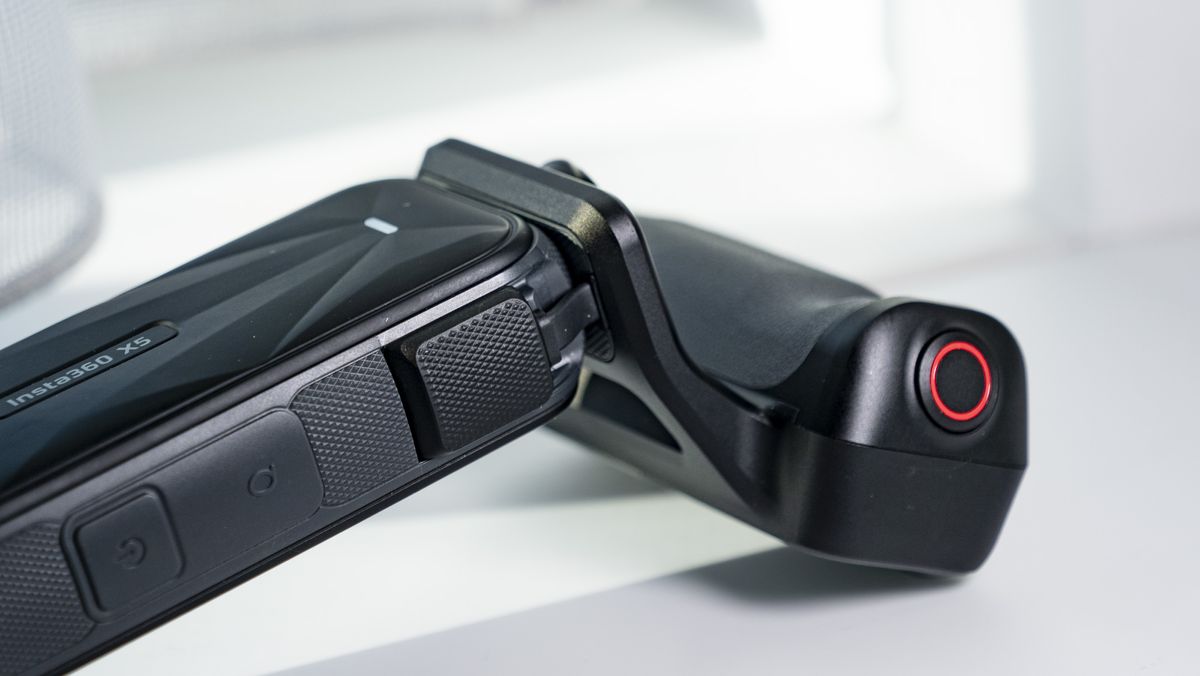 Insta360 X5 Photography Grip attached to the camera, on a plain white surface