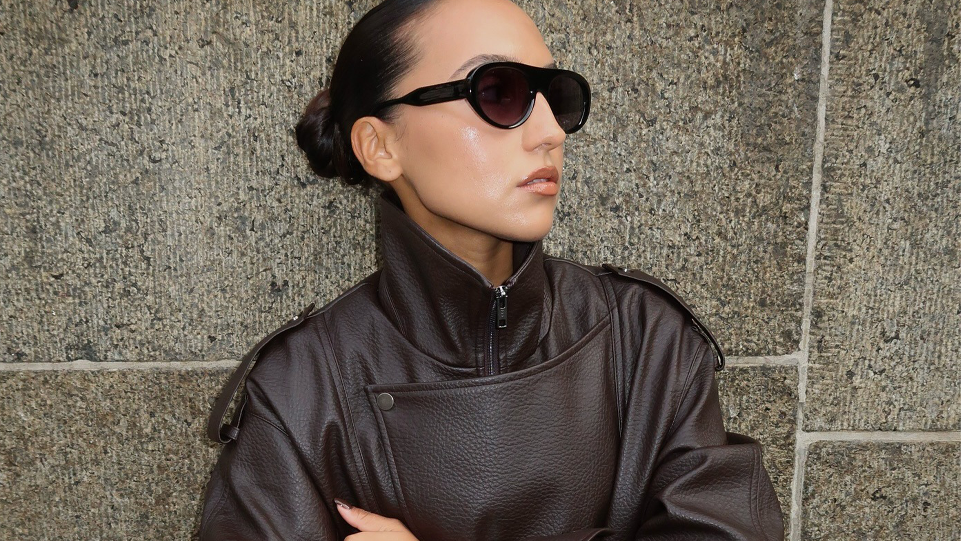 Woman wearing leather funnel neck jacket.