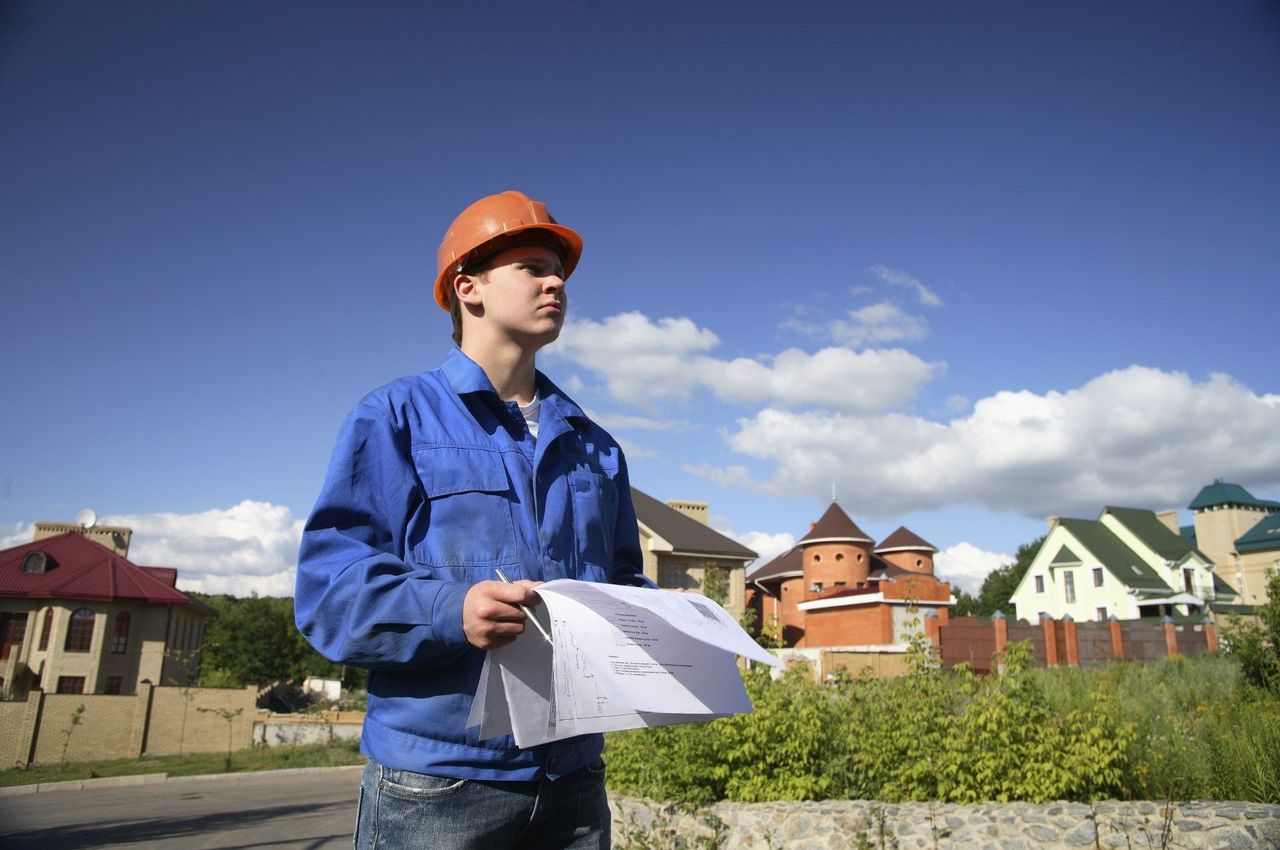 Landscape Designer Holding Blueprints In A Neighborhood