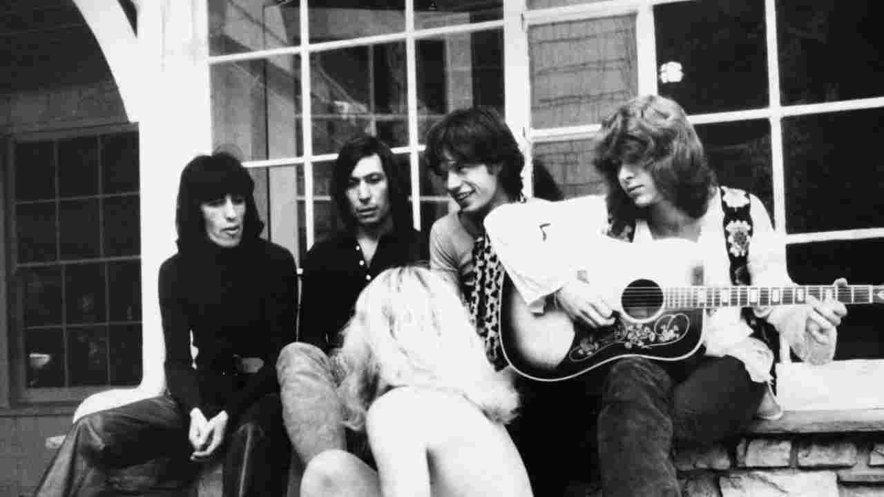 Rolling Stones posing for a photograph with a semi-naked girl in 1969