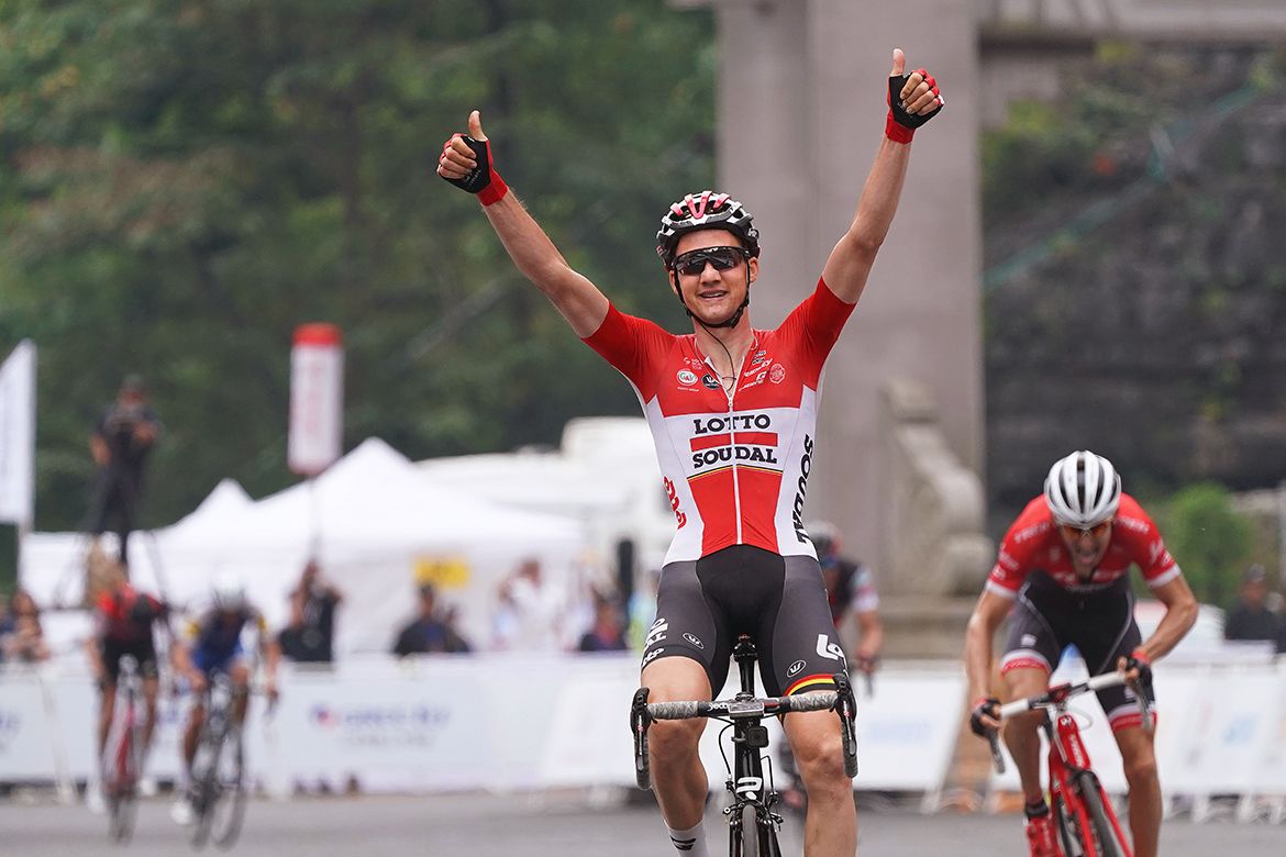 Tim Wellens raises his arms in celebration