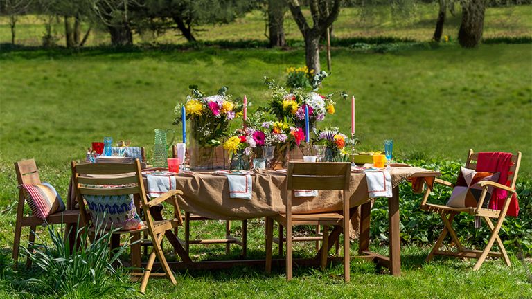 Outdoor birthday party ideas with wooden table and chairs