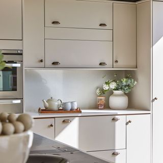 Cream coloured kitchen units and food prep area
