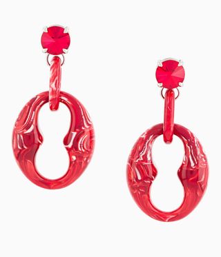 Woman's earring for unpierced ears by Prada. Chunky clip earrings in red metal with a rhinestone.