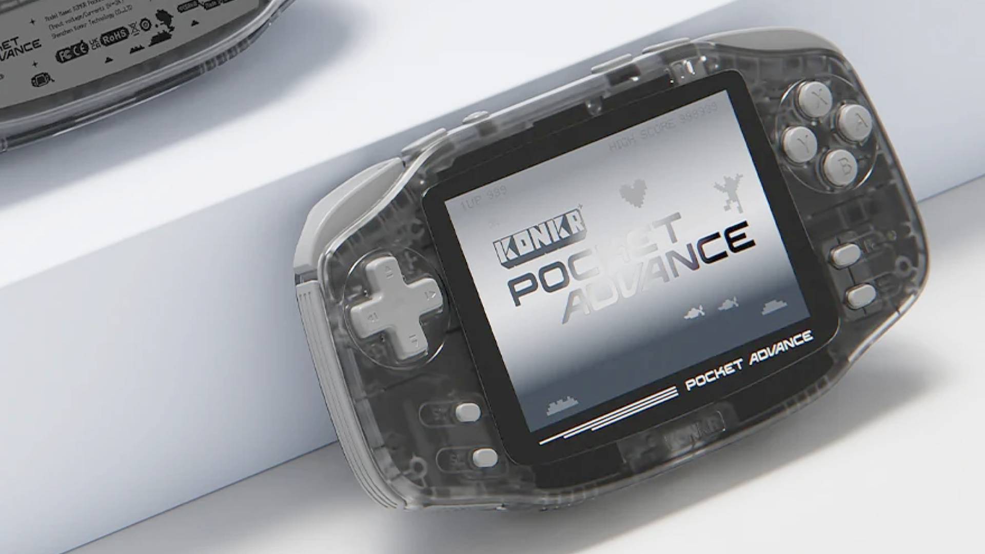 KONKR Pocket Advance handheld leaning against white block with logo on screen.
