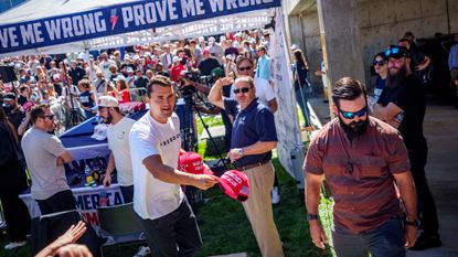 Conservative influencer Charlie Kirk tosses out hats shortly before he was shot dead at Utah Valley University.