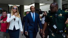 Tiger Woods (centre) and Vanessa Trump walk towards a south Florida courtroom on Wednesday, September 2