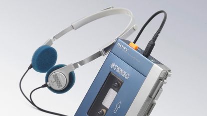 The original Sony Walkman TPS-L2 with its headphones on a grey background