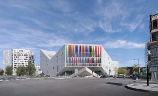 Maison Stéphane Hessel in Lille, France - a large concrete building with multi-coloured panels hanging on 1 wall