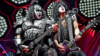 Kiss members Gene Simmons and Paul Stanley perform in the band's trademark costumes and makeup.