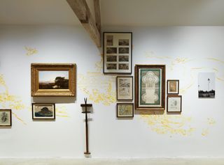 Photo frames on white wall with yellow sketches