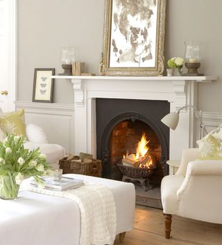 White and grey living room ideas with two chairs by fireplace
