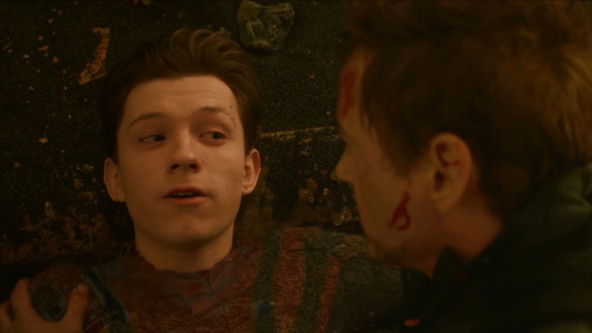 Peter Parker being held by Tony Stark on the ground right before he disintegrates in Avengers: Infinity War. 