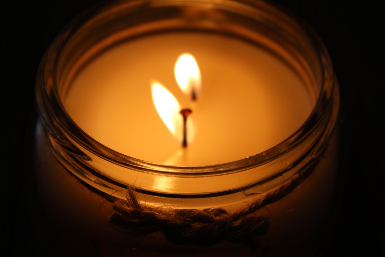 A candle lit in the dark.